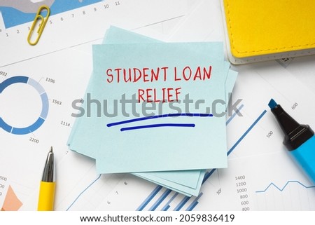  STUDENT LOAN RELIEF sign on the piece of paper. 
