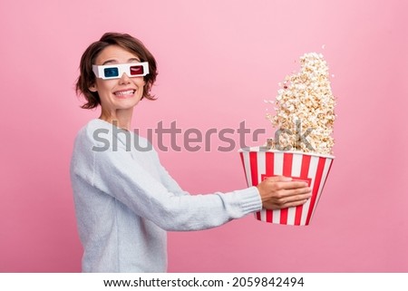 Photo of crazy lady hold popcorn bucket throw food wear 3d glasses blue sweater isolated pink color background