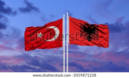 Turkey and Albania two flags on flagpoles and blue cloudy sky