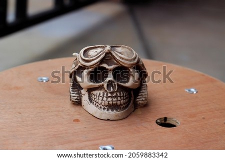 close up of a skull ashtray on tehe table.