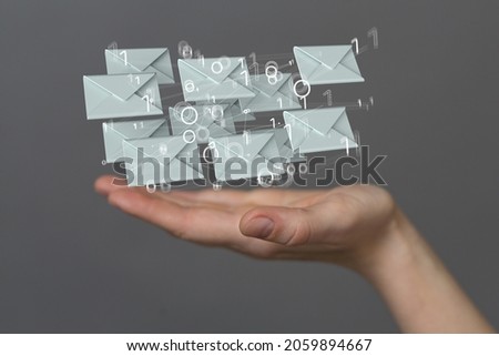 A human hand showing network communications with email symbol