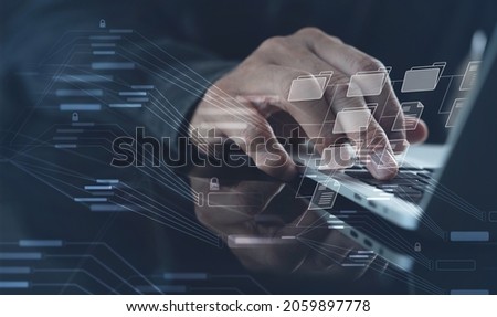 Document Management System (DMS) being setup by IT consultant working on laptop computer in office. Software for archiving, searching and managing corporate files and information Royalty-Free Stock Photo #2059897778