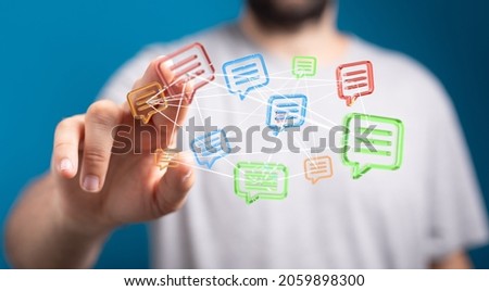 A man tapping floating 3D rendered colorful speech bubbles