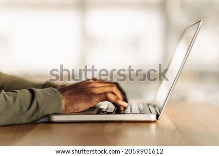 close-up of hands are typing on a laptop. side view. job search via the Internet. online work. online shopping. distance learning