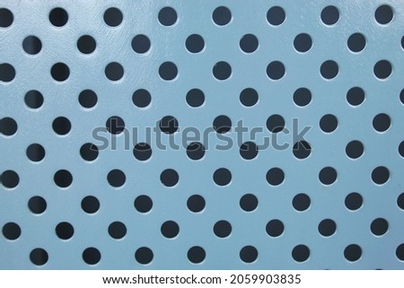The circular perforated steel sheet is painted to prevent rust in gray.