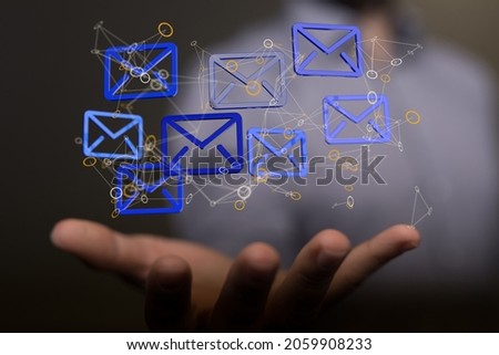 An abstract shot of a man's hand presenting 3D rendered digital email and message icons on the web