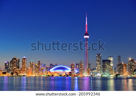 Toronto sunset over lake panorama with urban skyline.