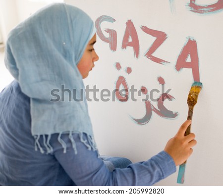 Arabic Muslim girl writing messages on board