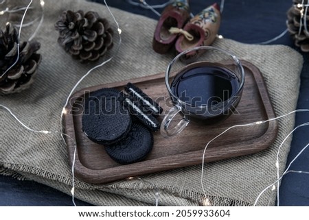 Cup of coffee with chocolate chip cookies on wooden tray. Concept for a tasty snack, Selective focus, Oblique view from the top. No focus, specifically.
