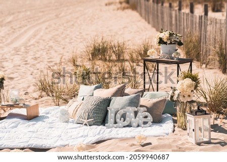 Luxury Picnic Proposal with bohemian and modern accents on a beach setting 