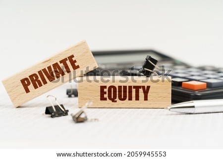 Business and finance concept. On a white background, a calculator, a pen, reports and wooden dies with the inscription - Private Equity Royalty-Free Stock Photo #2059945553