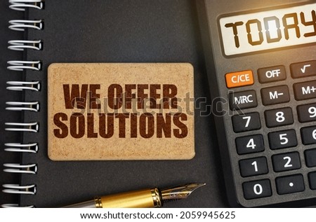 Business concept. On the notebook there is a calculator with the inscription Today and a sign with the inscription - We Offer Solutions