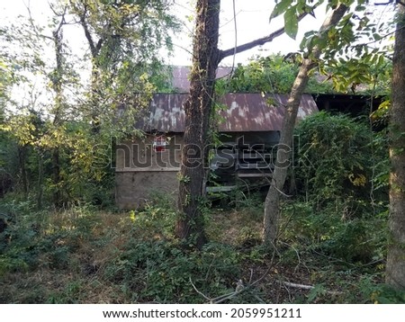 dilapidated house or shed with do not enter sign