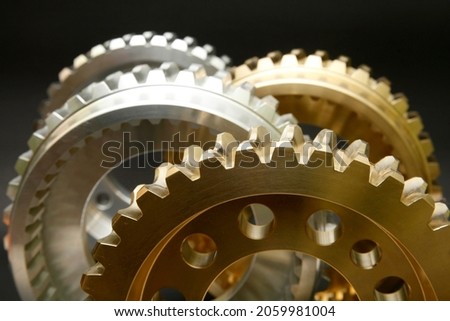 Steel and copper gears on a black background.
