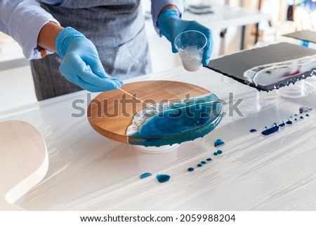 the process of making the sea on a two-component resin board, master class on resin art, indoor Royalty-Free Stock Photo #2059988204