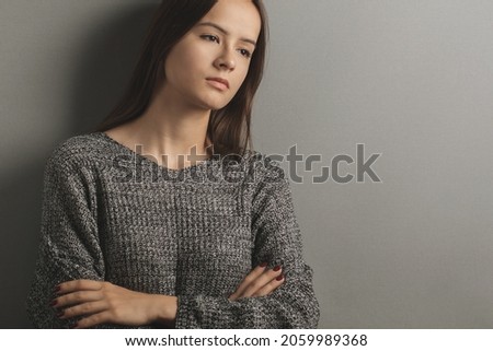 teen upset,unhappy sad teenage girl stands with her arms crossed,frustrated young woman,problems and misfortunes in her family and life,adolescent abuse Royalty-Free Stock Photo #2059989368