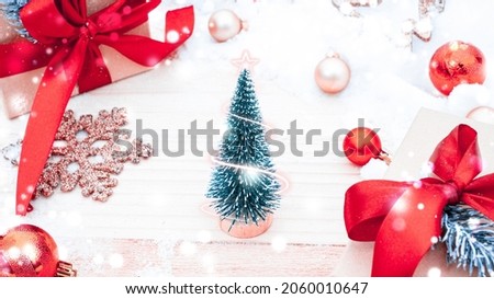 Table wood Christmas. Xmas board with old rustic wall, white frozen snow, golden balls and gift box. Winter wooden decoration background. Happy new year copy space