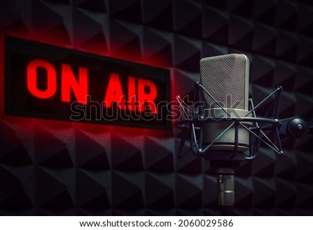 Professional microphone in radio station studio and on air sign Royalty-Free Stock Photo #2060029586