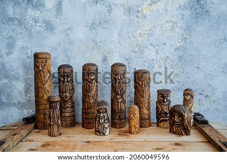 Wooden figures of small size. A set of Slavic different idols carved from wood. Toys and souvenirs of natural materials. High quality photo