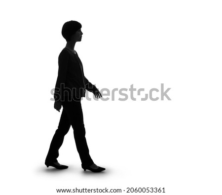 Silhouette of walking young asian woman.