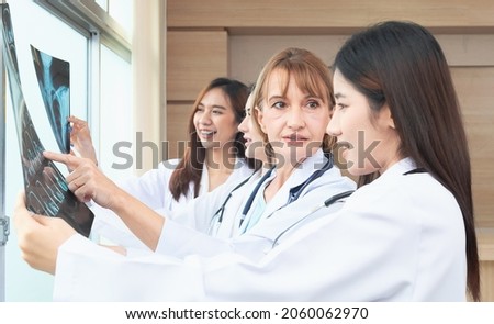 Group of intellectual healthcare professionals female doctors with at x-ray radiographic image, ct scan, mri