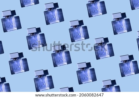 Fragnance parfume pattern. Bottles of blue woman perfume on a pastel blue background, flat lay, top view. Mockup of fragrance perfume. Trendy sunlight minimal concept.

 Royalty-Free Stock Photo #2060082647