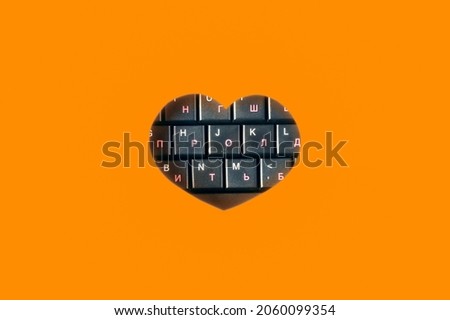 The heart inside which are the keys from the keyboard. Orange background. 