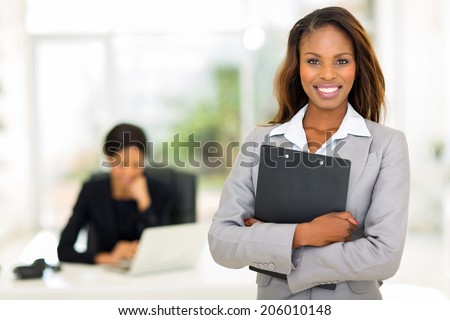 black business woman holding clipboard with colleague on background Royalty-Free Stock Photo #206010148