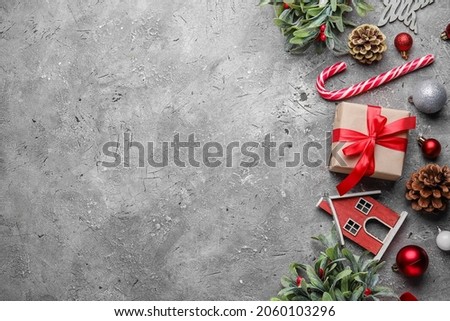Christmas composition with mistletoe branches and decor on grunge background