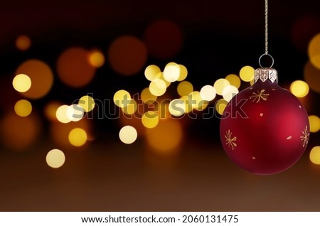 red Christmas ball on the background of Christmas lights