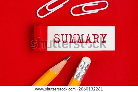 SUMMARY written on torn red paper with pencils and clips, business Royalty-Free Stock Photo #2060132261