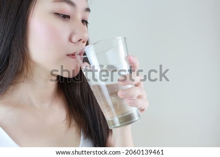 Asian beautiful women drink water for skin and health care, healthy lifestyle concept. Close up picture 