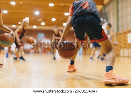 Young Basketball Player on Practice Session. Youth Basketball Team Bouncing Balls on Sports Court. Group of Kids Training Basketball Together  Royalty-Free Stock Photo #2060154047
