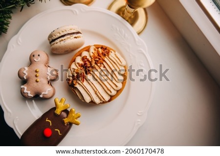 Christmas sweets: macaroon with cookies and caramel tart. New Years 2022 concept