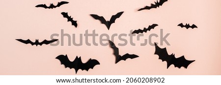Happy Halloween. Bats on a pink pastel background. Banner format. Banner format