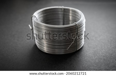 Wire spool on a dark background. Royalty-Free Stock Photo #2060212721