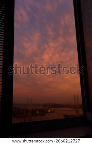 Sunset sky over city - view from window.