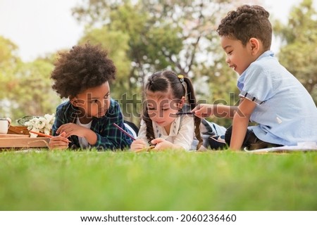 A boy teasing girl while her drawing picture