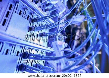 Multiple twisted-pair cables plugged into network switches Royalty-Free Stock Photo #2060241899