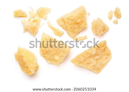 Pieces of parmesan cheese isolated on white background. Pattern. Parmesan  crumbs top view. Flat lay. Royalty-Free Stock Photo #2060251034