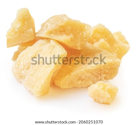 Hard mature cheese (Parmesan, Parmigiano), rough pieces. Pile of Parmesan cheese, side view Royalty-Free Stock Photo #2060251070