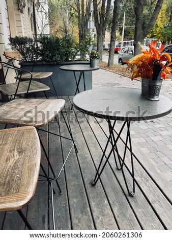 table and chairs with flowers on street