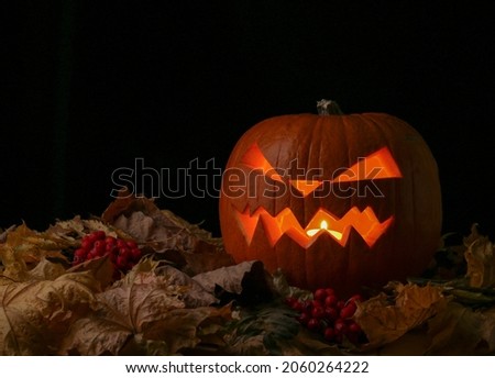 Halloween pumpkin with a burning candle