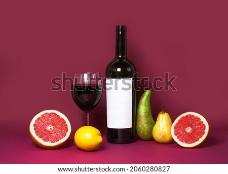 Refreshing colorful summer drinks with various fruits: pear, grapefruit, lemon on a pink background. Red wine and fruit. summer mood. copy space. advertisement. poster