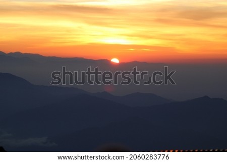 Mountain view with waterfall and sunrise