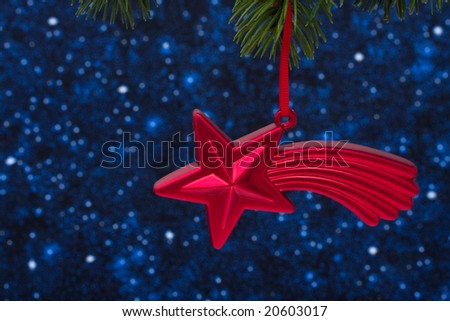 Christmas tree limb with red star glass ornament on star background, Christmas tree
