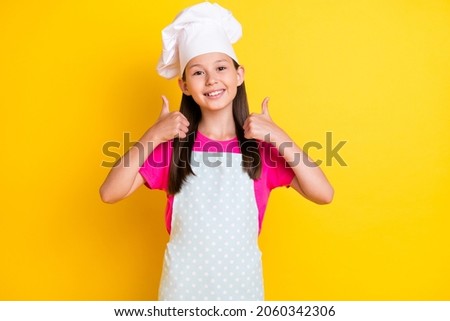 Photo of little chef lady raise thumb up approve meal diet wear white apron hat isolated yellow color background