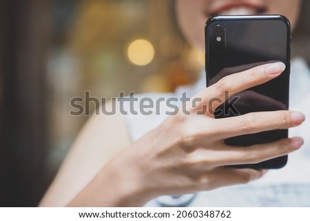 Selective focus on Young woman hand while using mobile smart phone by texting the message to communicate with someone, surf internet, buy product online shopping, copy space, modern technology concept
