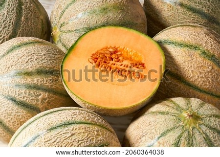 Whole and sliced ​​melon, honeydew melon or melon cantaloupe and food texture close up. Cantaloupe melon composition and design elements. Royalty-Free Stock Photo #2060364038