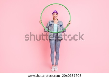 Full length photo of funny blond young lady do excercise wear jeans jacket visor isolated on pink color background